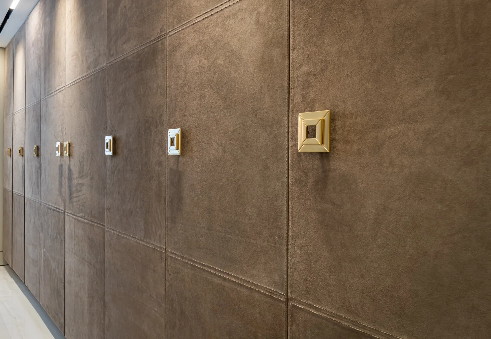 Stitched Cordova hide leather wall panels.