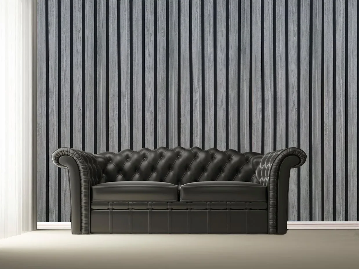 Gray Akupanel 3x1 wide slat panels behind a black leather sofa.