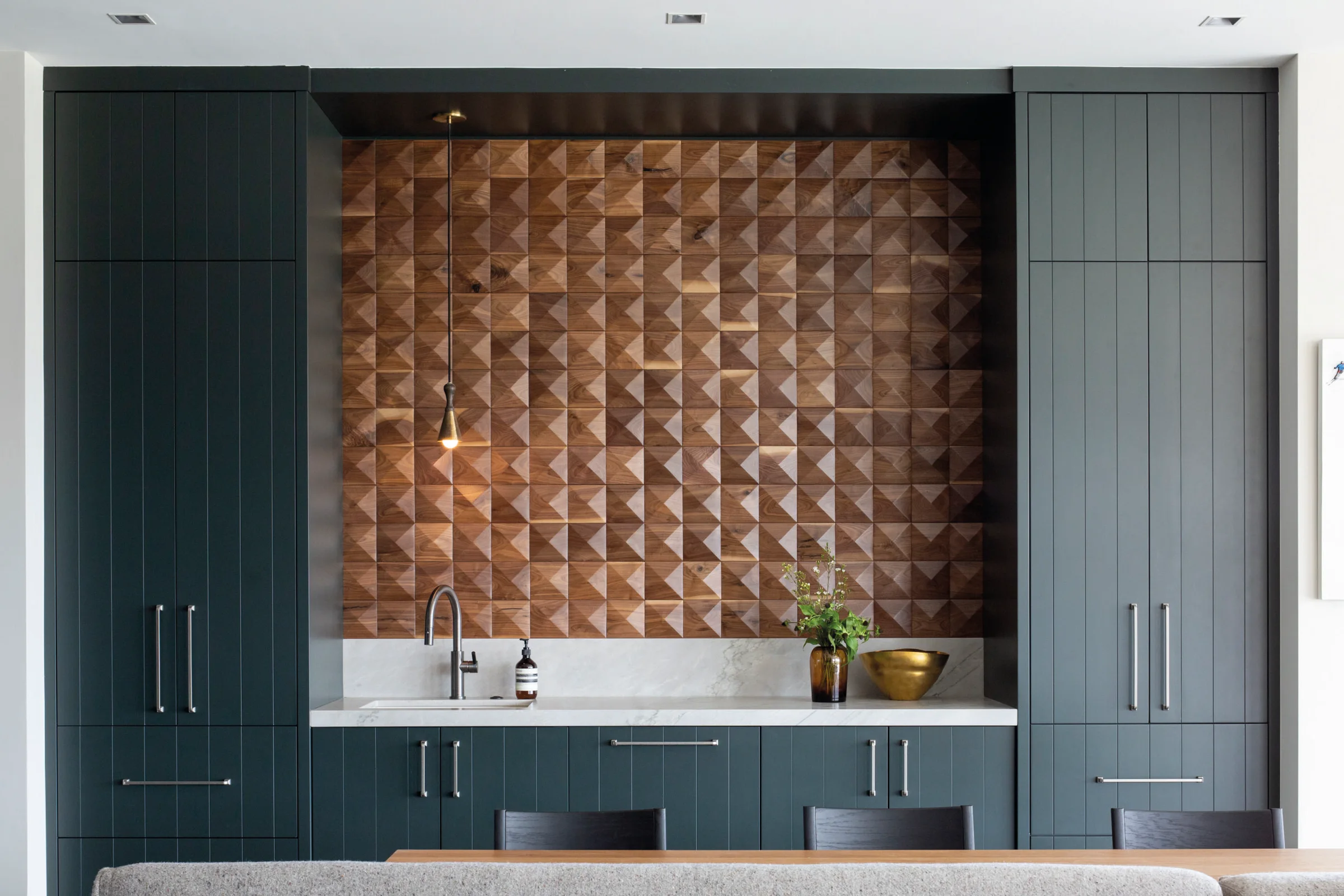 Pinnacle walnut panels in a kitchen niche. Design: Hudson Bloum.