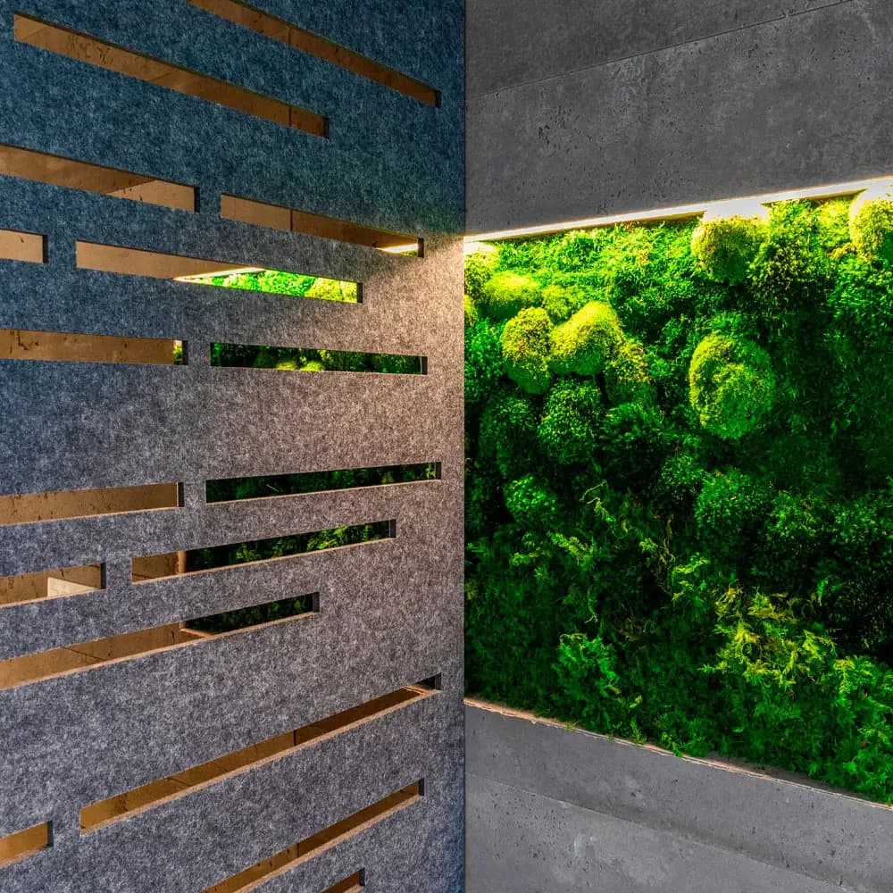 Ezobord Work Zone Divider screen with slots in front of a moss wall.