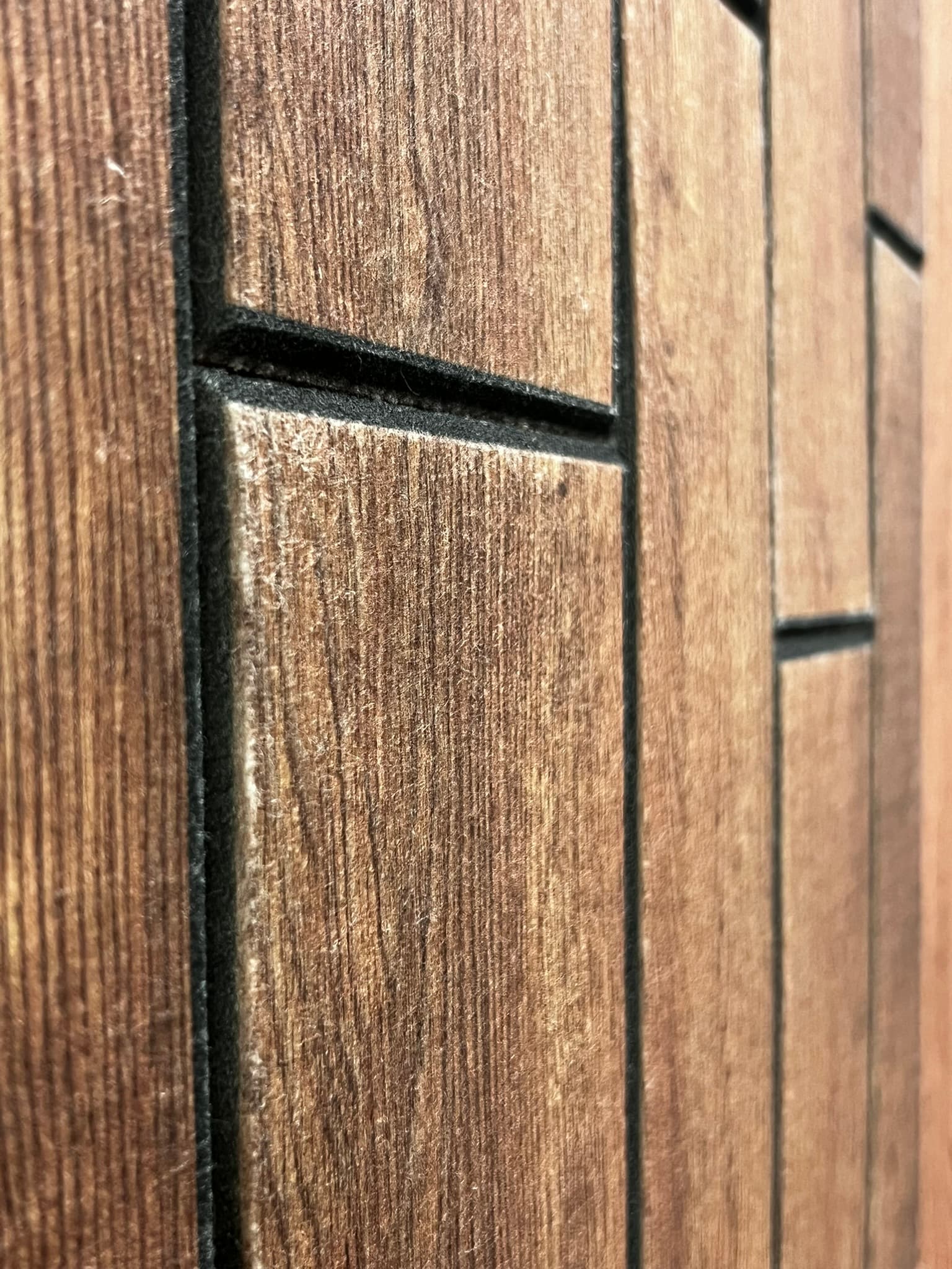 a dimensional acoustic wall panel featuring different variations of color to form a design