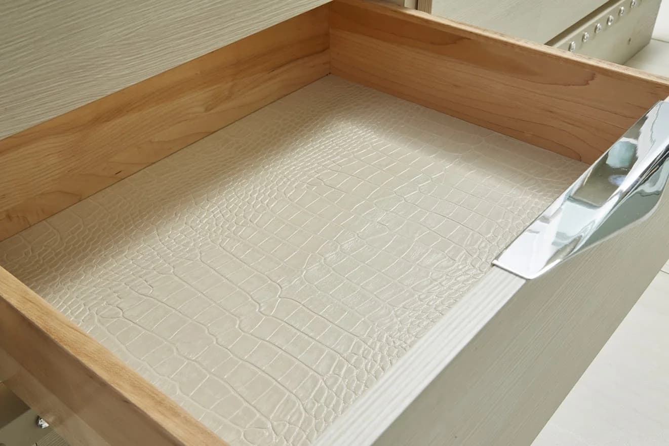 Crocodile-texture recycled leather veneer lining a drawer.