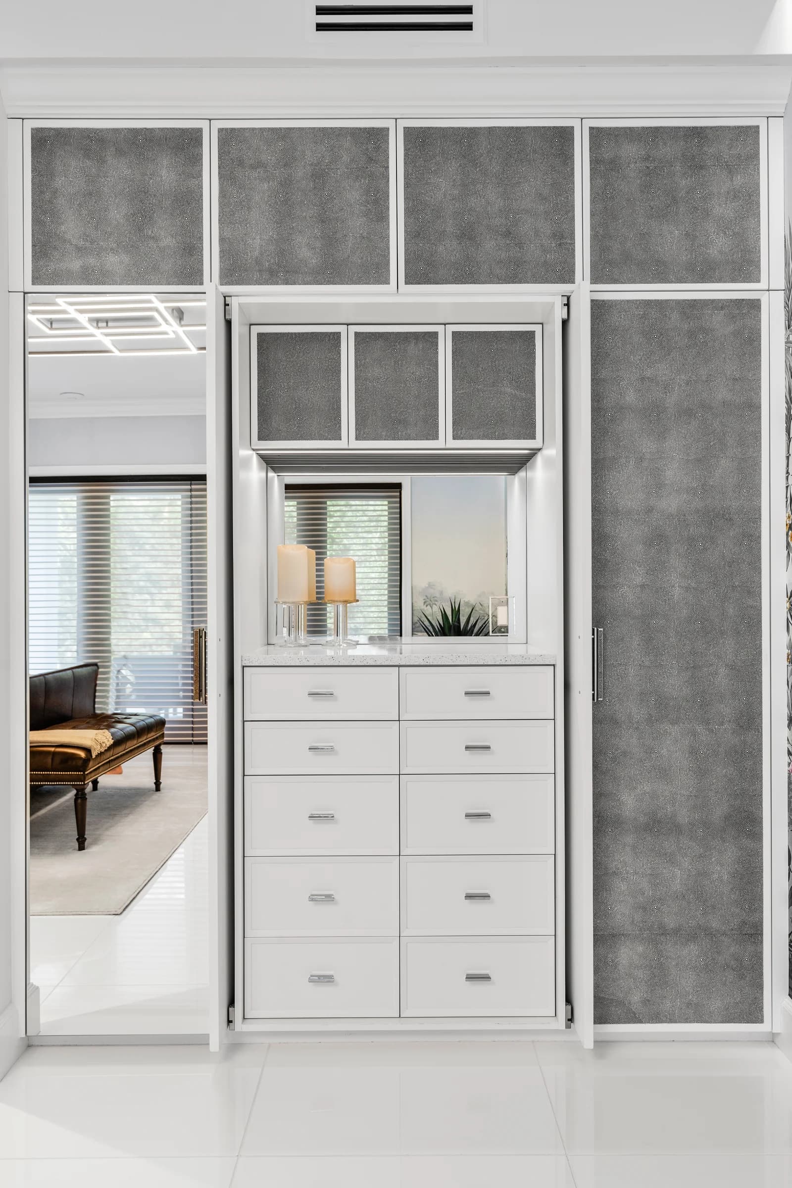 Grey recycled leather veneer inserts in a built-in wardrobe.