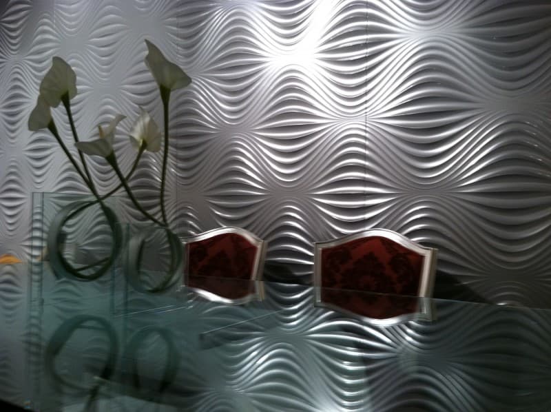 Close view of white Art Diffusion wave panels behind a table with calla lilies.