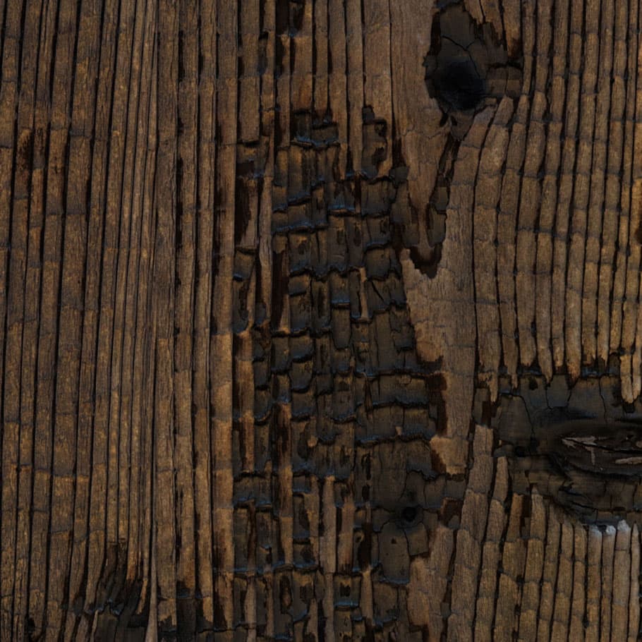 A woodgrain laminate pattern in brown tones, defined by natural grain movement and layered tonal variation