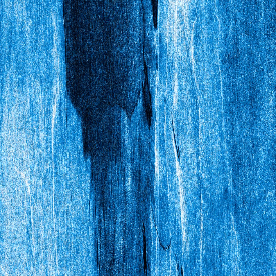 A woodgrain laminate pattern in balanced neutral and mid-tone hues, defined by natural grain movement and layered tonal variation